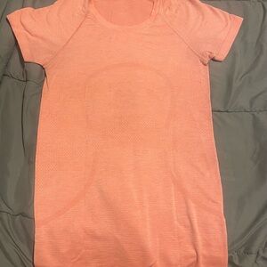 Lululemon swiftly tech short-sleeve 2.0 shirt hip length in pink. Tiny hole